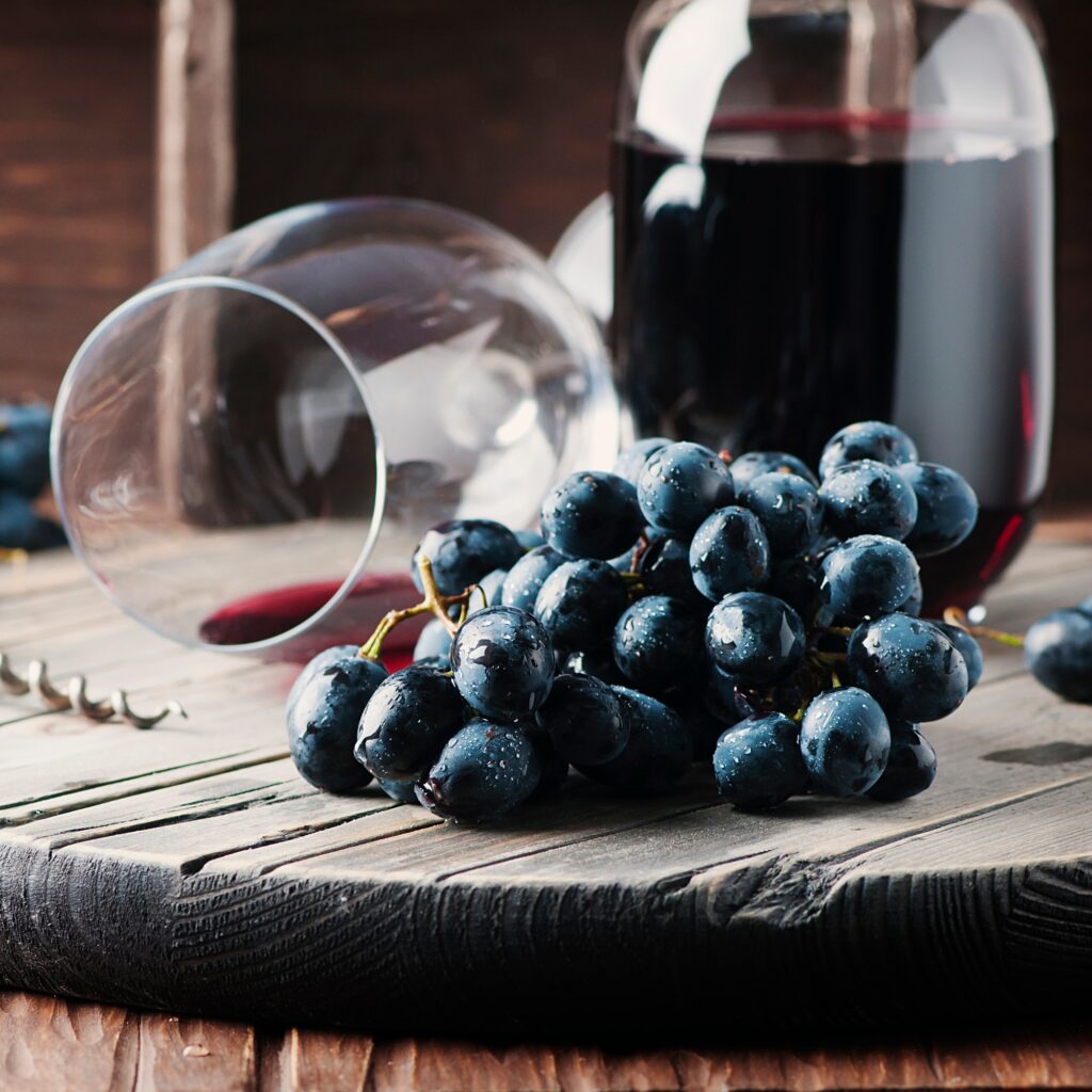 Fresh grape and red wine on the vintage table