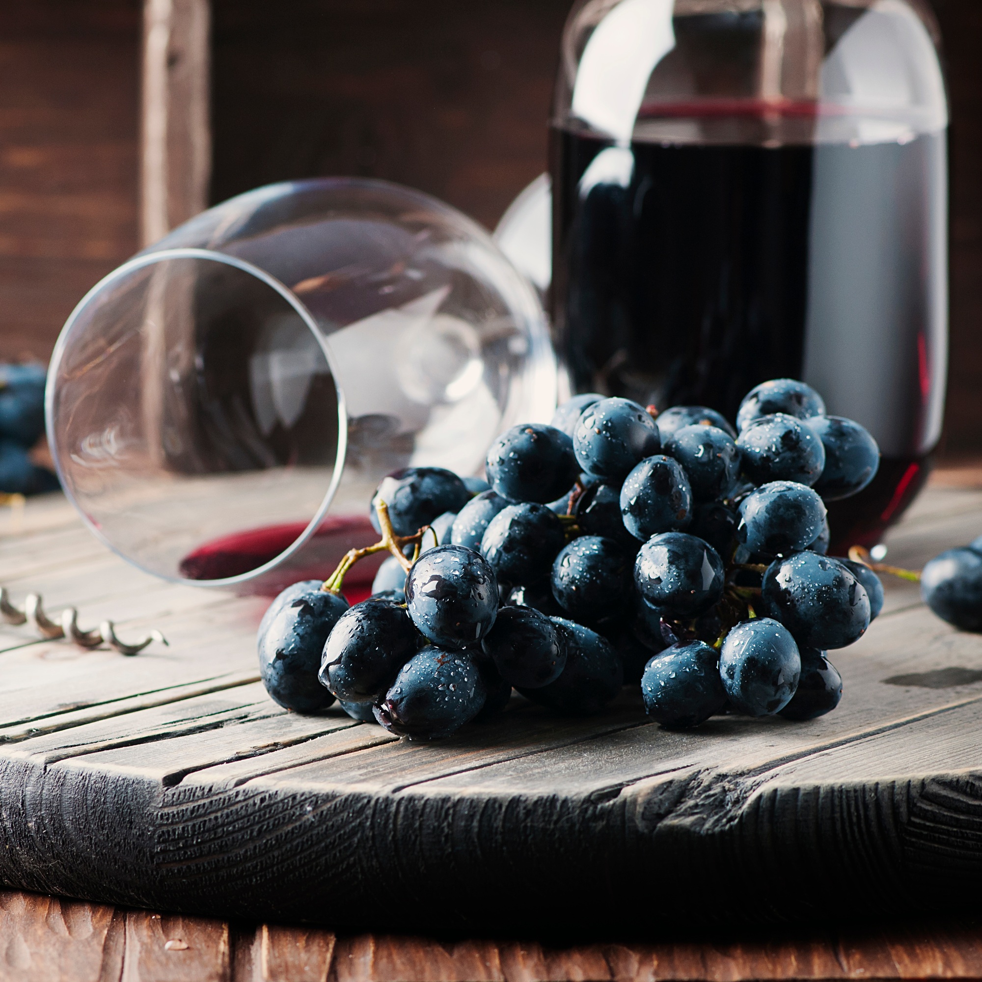 Fresh grape and red wine on the vintage table